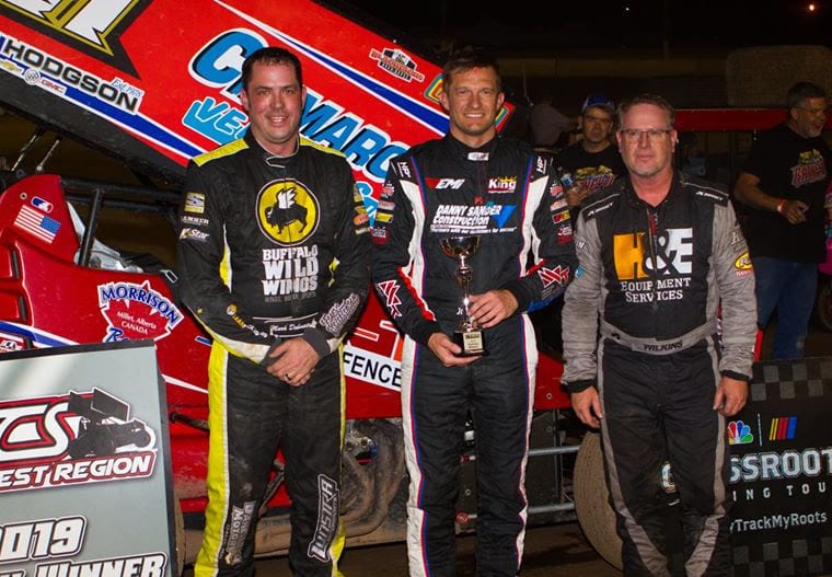 John Carney (center) is joined on the podium by Mark Dobmeier and Eric Wilkins. (Ron Gilson photo)