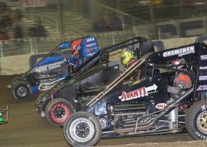 J.J. Yeley (2G), Tyler Edwards (73B) and Ricky Stenhouse Jr. race three-wide during Friday's Chili Bowl preliminary event. (Brendon Bauman Photo)