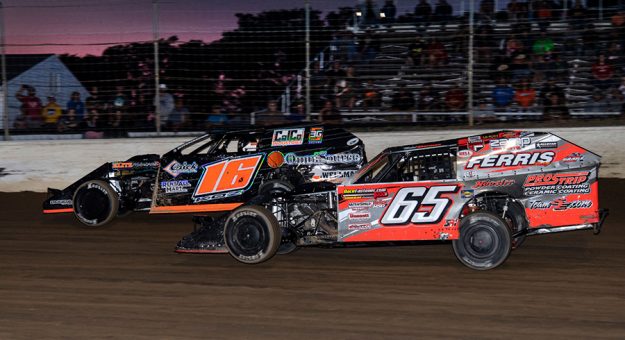 Todd Sherman dives low to pass feature leader Jeff Koz at Limaland Motorsports Park Friday. (Mike Campbell Photo)