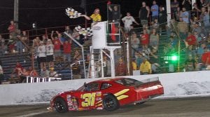 Kyle Crump takes the checkered flag to win the Redbud 400. (Jim Denhamer Photo)